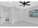 Well-lit bedroom with hardwood floors, a closet and a window that lets in natural light. The walls are painted white at 1914 E Emma St, Tampa, FL 33610