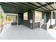 Covered carport area of a home with a staircase leading to the front door at 1914 E Emma St, Tampa, FL 33610