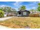 Single-story home with a functional carport and minimalist landscaping at 1914 E Emma St, Tampa, FL 33610