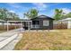Charming single-story home featuring a carport and well-maintained front yard at 1914 E Emma St, Tampa, FL 33610