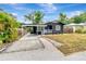 Cozy home showcasing a covered parking area and inviting front entrance at 1914 E Emma St, Tampa, FL 33610