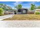 Charming home featuring a front porch, front yard, and ample parking at 1914 E Emma St, Tampa, FL 33610