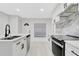 Sleek kitchen featuring a functional island, marble countertops, and modern appliances at 1914 E Emma St, Tampa, FL 33610