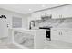 Modern kitchen with marble countertops, white cabinetry, and stainless steel appliances at 1914 E Emma St, Tampa, FL 33610