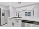 Bright kitchen with stainless steel appliances, shaker cabinets, modern sink, and an open layout with lots of light at 1914 E Emma St, Tampa, FL 33610