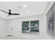 Spacious living room filled with natural light boasts modern ceiling fan and sleek floors at 1914 E Emma St, Tampa, FL 33610