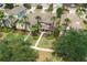 Aerial view of a home with well-manicured lawn, lush landscaping, and stunning palm trees at 20039 Heritage Point Dr, Tampa, FL 33647