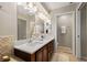 Bathroom featuring a dual sink vanity, tile floor, and a glass enclosed shower at 20039 Heritage Point Dr, Tampa, FL 33647