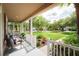 Inviting front porch with seating area and beautifully landscaped front yard at 20039 Heritage Point Dr, Tampa, FL 33647