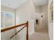 Hallway with wood railing staircase and windows leading to bedrooms at 20039 Heritage Point Dr, Tampa, FL 33647