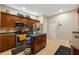 Spacious kitchen with stainless steel appliances, granite countertops, wood cabinetry, and tile flooring at 20039 Heritage Point Dr, Tampa, FL 33647