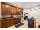 Well-maintained kitchen featuring hardwood cabinets, tile floors, stainless steel appliances and view into a living area at 20039 Heritage Point Dr, Tampa, FL 33647