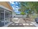 Spacious backyard with stone pavers leading to a screened in patio and lush landscaping at 2020 Elk Spring Dr, Brandon, FL 33511