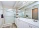 Bathroom featuring double sinks, modern vanities, large mirrors, and a glass-enclosed shower at 2020 Elk Spring Dr, Brandon, FL 33511