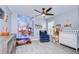 bedroom with grey walls, wood-look floors, ceiling fan, and decorations with cartoon characters at 2020 Elk Spring Dr, Brandon, FL 33511