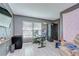 Gaming bedroom with grey walls, laminate floors, work desk, and large flat screen tv at 2020 Elk Spring Dr, Brandon, FL 33511