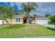 Charming single-story home with a well-maintained lawn and mature palm trees adding curb appeal at 2020 Elk Spring Dr, Brandon, FL 33511