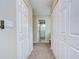 Hallway featuring multiple white closets and an entry to the bathroom with glass shower at 2020 Elk Spring Dr, Brandon, FL 33511