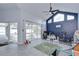Living space features vaulted ceilings, a blue accent wall, and sliding glass doors leading to a screened patio at 2020 Elk Spring Dr, Brandon, FL 33511