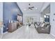 Open living area with a statement wall, stylish flooring, and a comfortable sectional sofa, ideal for relaxation at 2020 Elk Spring Dr, Brandon, FL 33511