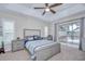 Bedroom featuring a tray ceiling, neutral color palette, and a sliding glass door to the backyard at 2020 Elk Spring Dr, Brandon, FL 33511