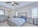 Bedroom with neutral colors, tray ceiling, and carpet flooring, featuring two nightstands and a dresser at 2020 Elk Spring Dr, Brandon, FL 33511