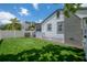 Spacious backyard features an artificial turf lawn, new fence, and steps up to outdoor bar at 209 S Arrawana Ave, Tampa, FL 33609