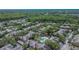 Overhead shot of the community featuring lush trees, tile roofs, and a sparkling community pool at 2220 Chianti Pl # 8-0828, Palm Harbor, FL 34683