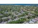 An aerial view featuring tile roofs, mature trees, and neighborhood layout, offering a tranquil lifestyle at 2220 Chianti Pl # 8-0828, Palm Harbor, FL 34683