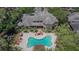 Aerial view of building with a large pool, patio, mature trees and lush landscaping at 2220 Chianti Pl # 8-0828, Palm Harbor, FL 34683
