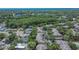 Bird's eye view of the community displaying well-maintained roofs, mature trees, and a tranquil neighborhood setting at 2220 Chianti Pl # 8-0828, Palm Harbor, FL 34683