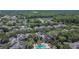 Aerial image showcases the community with mature landscaping and a large pool and clubhouse at 2220 Chianti Pl # 8-0828, Palm Harbor, FL 34683