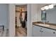 Bathroom featuring a sink and mirror, along with access to an organized walk-in closet at 2220 Chianti Pl # 8-0828, Palm Harbor, FL 34683