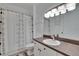 Bright bathroom featuring vanity, sink, shower with curtain and good lighting at 2220 Chianti Pl # 8-0828, Palm Harbor, FL 34683