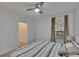 A bright bedroom with a ceiling fan, window with curtains, and light wood flooring at 2220 Chianti Pl # 8-0828, Palm Harbor, FL 34683