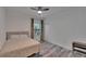 Bedroom with a ceiling fan, window with natural light, and light hardwood floors at 2220 Chianti Pl # 8-0828, Palm Harbor, FL 34683
