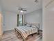 Bedroom featuring a comfortable bed, ceiling fan, and a window with natural light at 2220 Chianti Pl # 8-0828, Palm Harbor, FL 34683