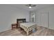 Bedroom featuring a ceiling fan, natural light from the window, and wood-look flooring at 2220 Chianti Pl # 8-0828, Palm Harbor, FL 34683