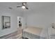 Bright bedroom features ceiling fan, light gray flooring, and a comfy-looking bed with cream colored comforter at 2220 Chianti Pl # 8-0828, Palm Harbor, FL 34683