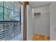 View of closet with metal shelving and window with blinds, showing natural light and wood flooring at 2220 Chianti Pl # 8-0828, Palm Harbor, FL 34683