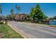 Charming townhouse showcasing a gated entry, lush landscaping, and tranquil water views at 2220 Chianti Pl # 8-0828, Palm Harbor, FL 34683