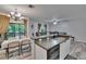 Kitchen with open concept to living room, breakfast bar, and backyard views at 2220 Chianti Pl # 8-0828, Palm Harbor, FL 34683
