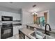 Modern kitchen featuring stainless steel appliances and easy access to the dining area at 2220 Chianti Pl # 8-0828, Palm Harbor, FL 34683
