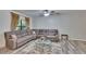 Spacious living room featuring a comfortable sectional sofa, coffee table, and contemporary decor at 2220 Chianti Pl # 8-0828, Palm Harbor, FL 34683