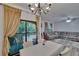 View of living room and balcony with sliding glass doors and chandelier at 2220 Chianti Pl # 8-0828, Palm Harbor, FL 34683