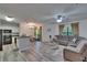Open living room with wood-look floors, ceiling fan, and combined dining and kitchen area at 2220 Chianti Pl # 8-0828, Palm Harbor, FL 34683