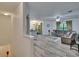 Open living space with wood-look floors, neutral walls, and sliding door to outdoor patio at 2220 Chianti Pl # 8-0828, Palm Harbor, FL 34683