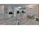 Open-concept living area with wood-look floors, modern lighting, and breakfast bar at 2220 Chianti Pl # 8-0828, Palm Harbor, FL 34683