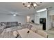 Living area flows into the kitchen, featuring a breakfast bar, living room and chandelier at 2220 Chianti Pl # 8-0828, Palm Harbor, FL 34683