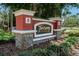 Community entrance sign with stone and stucco pillars at 2220 Chianti Pl # 8-0828, Palm Harbor, FL 34683